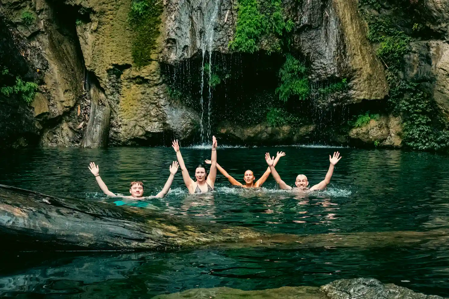 a group of people in a body of water with their arms raised-day 2-4-Day Private Tour – Motorbike flipside vietnam