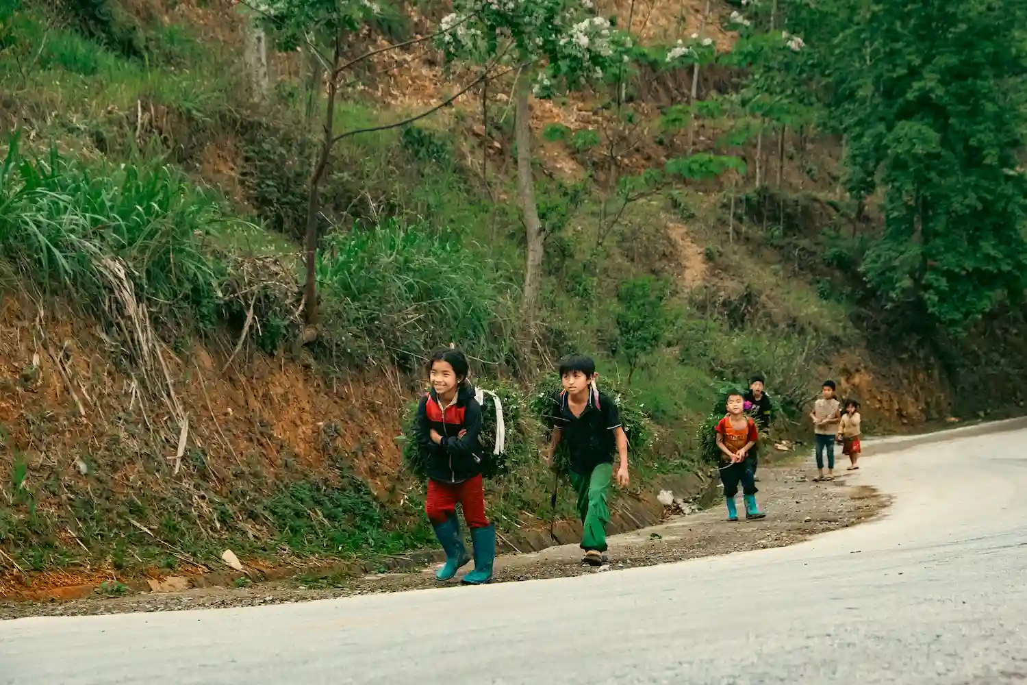 a group of children walking on a road-day 1-3-Day Private Tour – 4x4 flipside vietnam